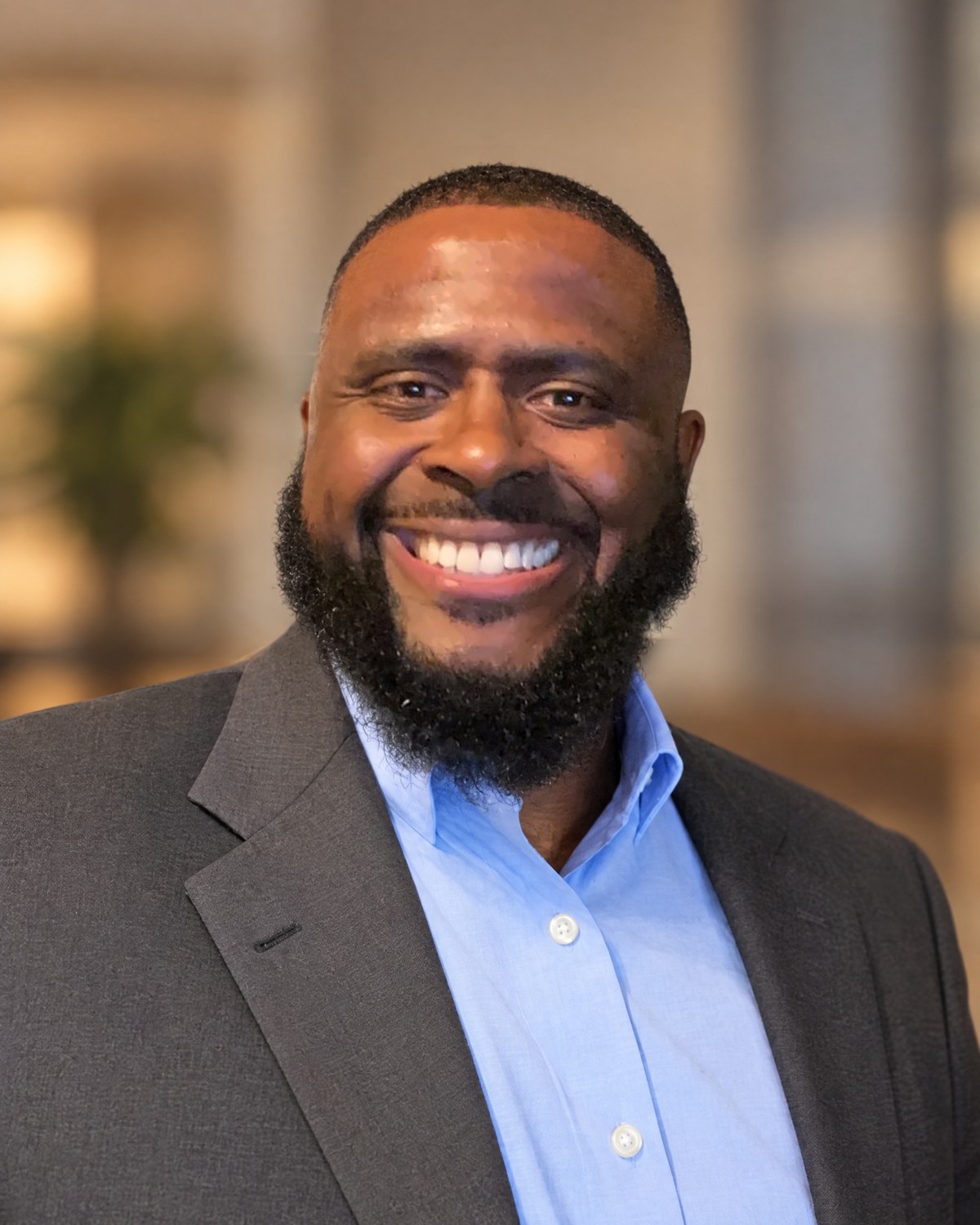 Dr. William L. Banks III in a gray blazer and light blue shirt, smiling.