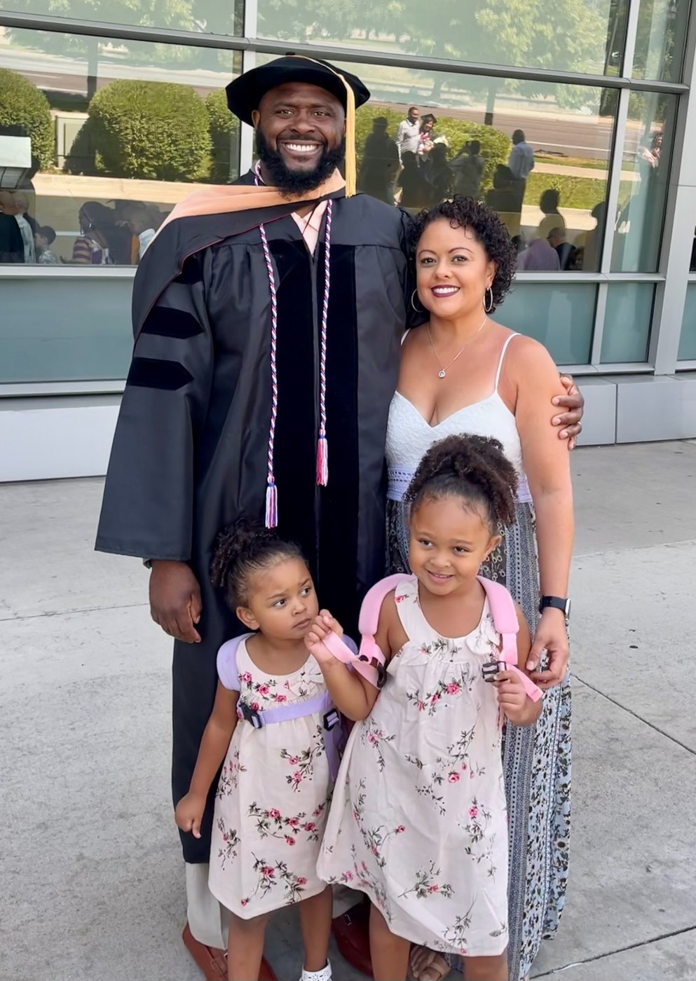 Dr. Banks in doctoral regalia with his wife and two daughters on graduation day.